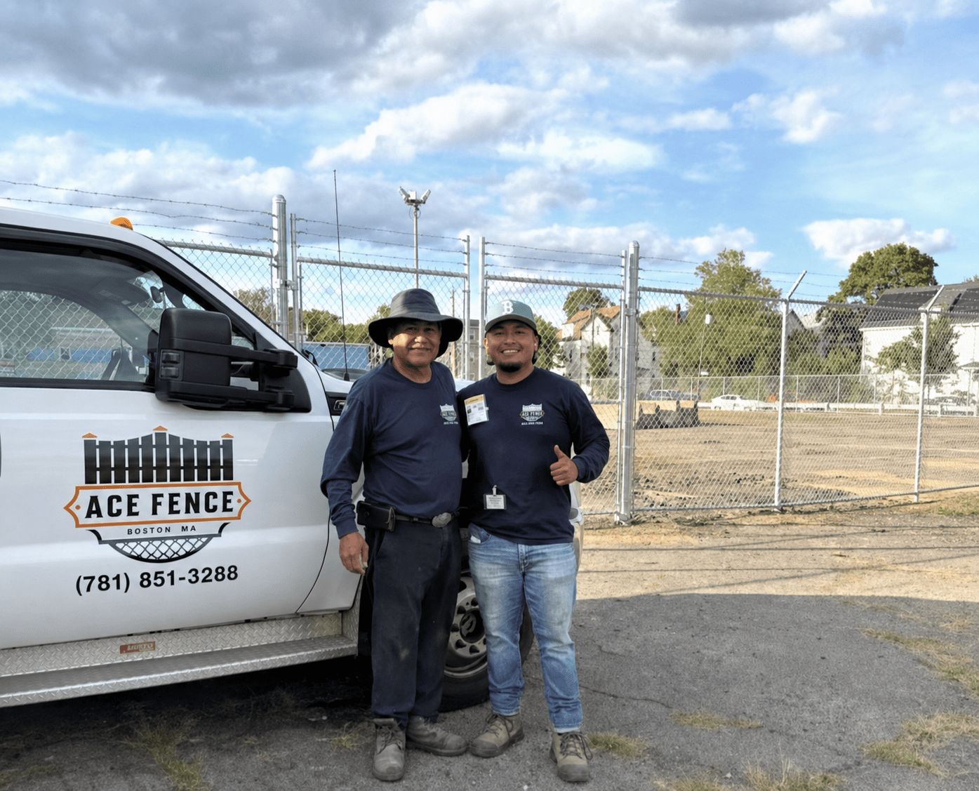 Ace Fence team beside a completed chain-link fence