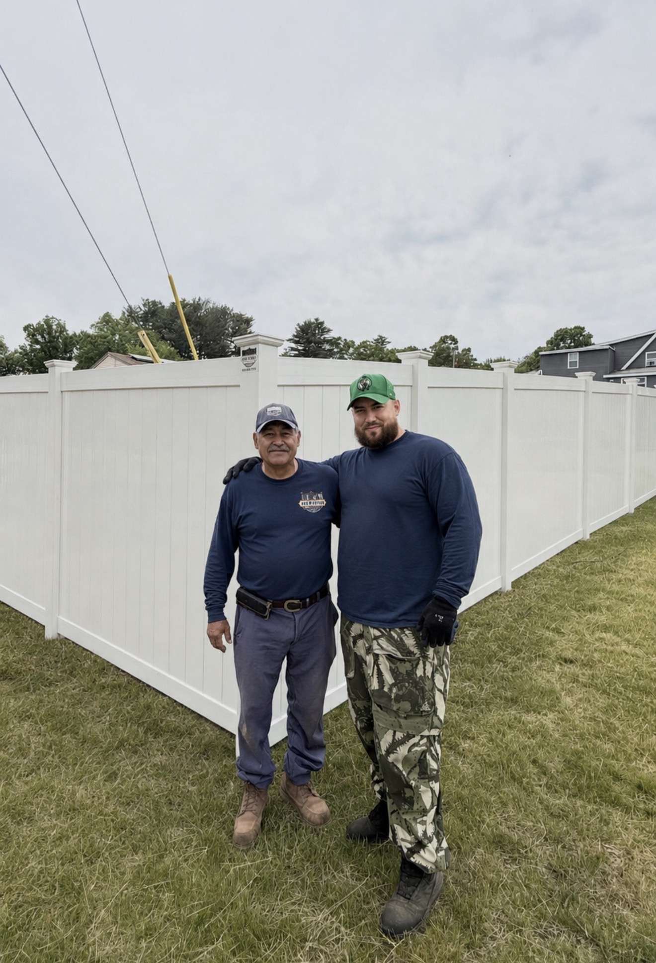 Ace Fence team standing in front of a completed white vinyl privacy fence